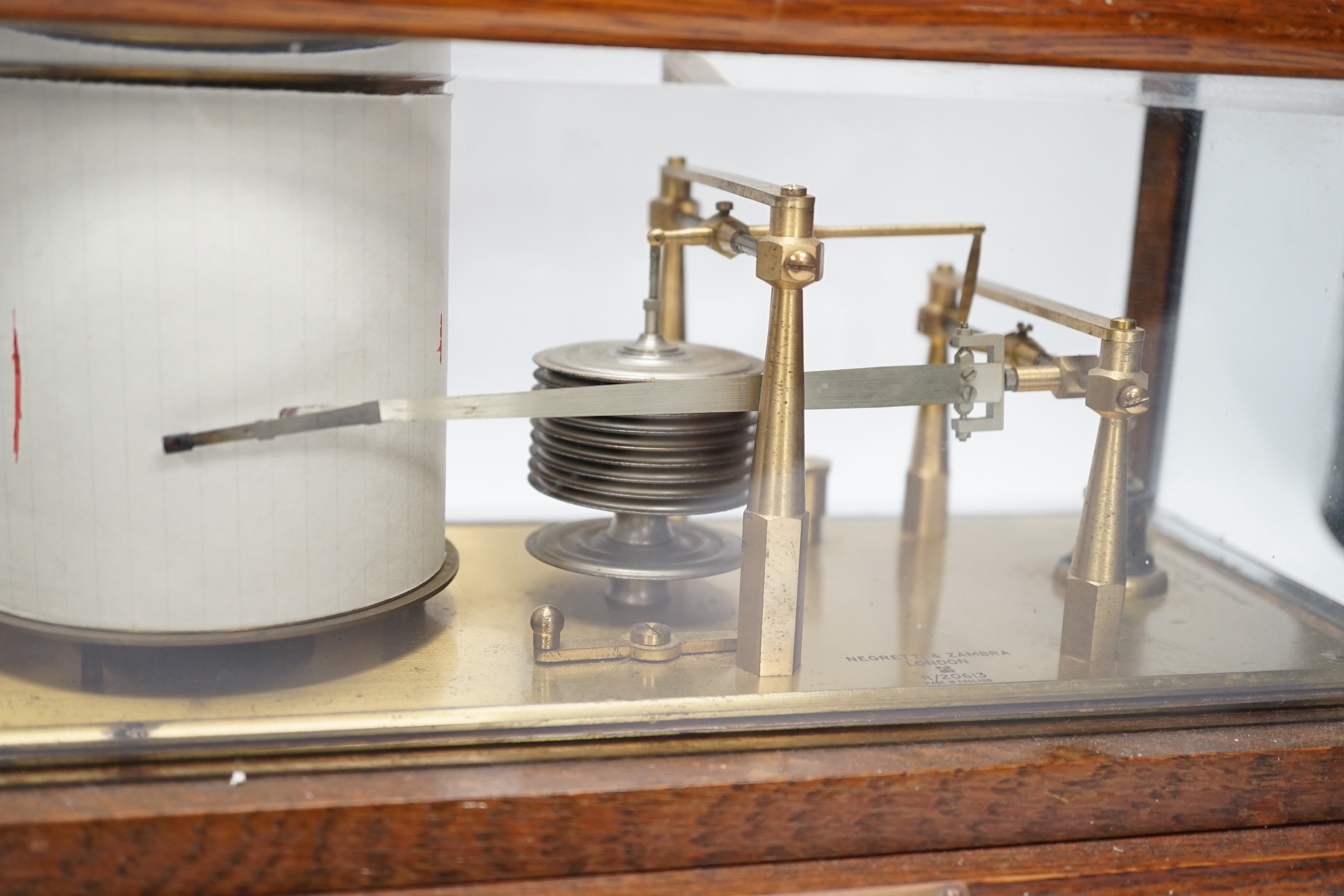 A Negretti and Zambra oak-cased barograph, number R/20613 with plaque reading ‘To C.C. Prigge as a token of esteem from his C.P.C. and B&P friends, July 1949’